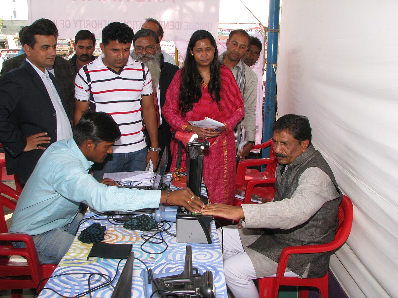 FairPlay KYC Registration: Aadhaar, PAN and passport documents beside a phone showing identity, document and account verification