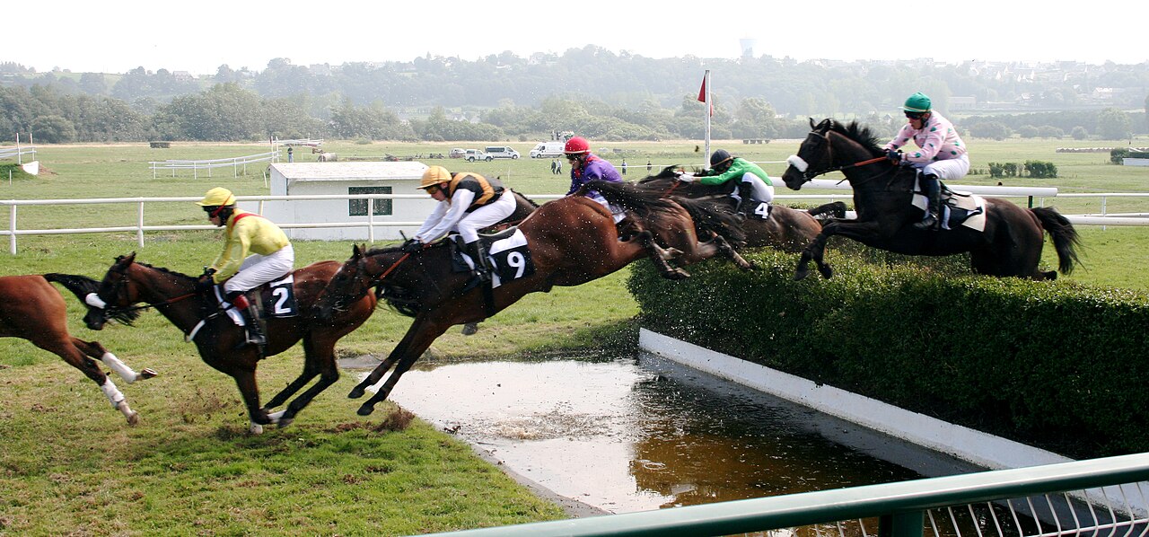 FairPlay Pune Racing Conditions: a board showing track condition, going, distance, temperature and wind beside horses in a race