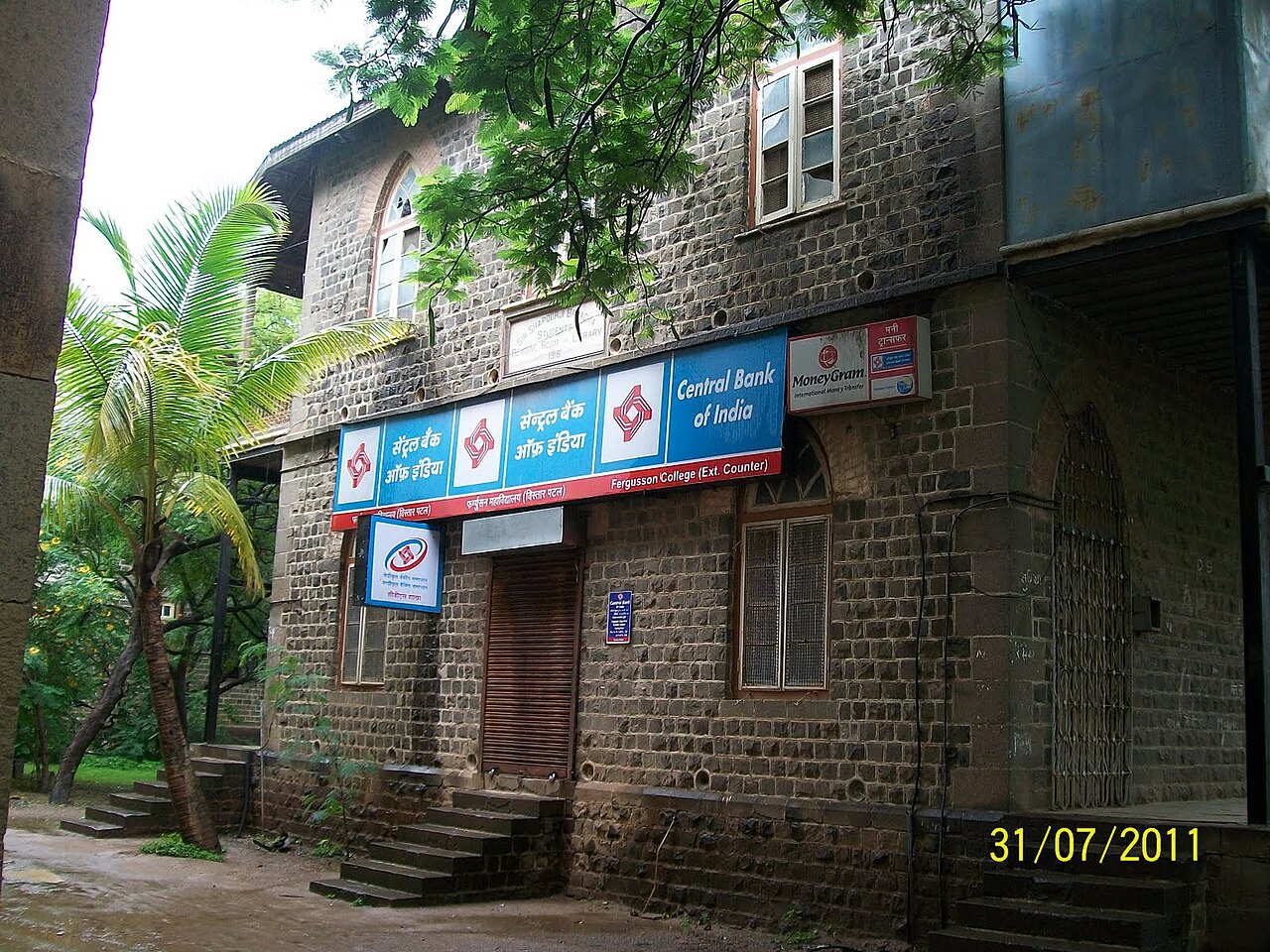 FairPlay Bank Withdrawal: a withdrawal confirmed on a phone beside a bank building and stacked coins